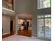 Living room view into kitchen and dining area, with hardwood floors and deck access at 5679 Coopers Glen Ct, Mableton, GA 30126