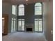 Bright living room with fireplace and floor-to-ceiling windows at 5679 Coopers Glen Ct, Mableton, GA 30126