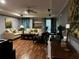 Cozy living room featuring wood floors, comfortable seating, and modern decor at 5679 Coopers Glen Ct, Mableton, GA 30126