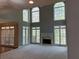 Bright living room with fireplace and floor-to-ceiling windows at 5679 Coopers Glen Ct, Mableton, GA 30126