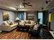 Cozy living room featuring hardwood floors, comfortable seating, and natural light at 5679 Coopers Glen Ct, Mableton, GA 30126