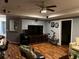 A large living room with hard wood floors, television, exercise equipment, and dart board at 5679 Coopers Glen Ct, Mableton, GA 30126