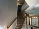 View of carpeted staircase with wood and white railing leading to the upper level, with natural light at 5679 Coopers Glen Ct, Mableton, GA 30126