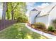 The spacious backyard is enclosed by a wooden fence and features a well-maintained lawn and landscaped pathway at 11140 Brookhollow Trl, Alpharetta, GA 30022