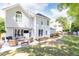 Spacious backyard featuring a patio with outdoor seating, a lush lawn, and mature trees for privacy at 11140 Brookhollow Trl, Alpharetta, GA 30022