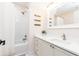 Bright bathroom features a single sink vanity with a tub and shower with white tiles and white trim at 11140 Brookhollow Trl, Alpharetta, GA 30022
