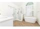 Bright bathroom with modern fixtures, standalone tub, glass shower, and a large window for natural light at 11140 Brookhollow Trl, Alpharetta, GA 30022