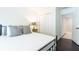 Bright bedroom featuring a closet, bedside table, and neutral decor for comfort and convenience at 11140 Brookhollow Trl, Alpharetta, GA 30022