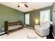 Inviting Bedroom featuring a crib, rocking chair, and plush rug with windows for natural light at 11140 Brookhollow Trl, Alpharetta, GA 30022