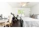 Bright bedroom featuring a large window, Peloton, desk, and ceiling fan for comfort and convenience at 11140 Brookhollow Trl, Alpharetta, GA 30022
