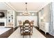 Dining room with a large table and chairs next to open concept floorplan at 11140 Brookhollow Trl, Alpharetta, GA 30022