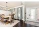 Elegant dining room featuring a large table, stylish lighting, and dark hardwood floors at 11140 Brookhollow Trl, Alpharetta, GA 30022