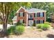 Charming two-story brick home featuring lush landscaping and a welcoming entrance at 11140 Brookhollow Trl, Alpharetta, GA 30022