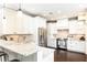 Bright kitchen showcasing stainless steel appliances, granite countertops, and white cabinetry at 11140 Brookhollow Trl, Alpharetta, GA 30022