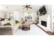 Bright living room featuring a fireplace, built-in shelving, large window, and comfortable seating at 11140 Brookhollow Trl, Alpharetta, GA 30022
