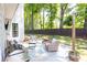 Outdoor patio with wicker furniture and a grill that is adjacent to a fenced in lawn at 11140 Brookhollow Trl, Alpharetta, GA 30022