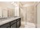 Bathroom featuring double vanity, granite countertops, and walk-in shower with glass door at 1780 Morningtide Ne Ln, Atlanta, GA 30324