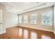 Spacious bedroom with tray ceiling, hardwood flooring, and large windows at 1780 Morningtide Ne Ln, Atlanta, GA 30324