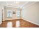 Inviting bedroom featuring tray ceilings, recessed lighting, rich hardwood flooring, and natural light at 1780 Morningtide Ne Ln, Atlanta, GA 30324