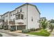 Exterior view of townhomes showcasing garages, decks, and landscaping at 1780 Morningtide Ne Ln, Atlanta, GA 30324