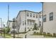 Beautiful townhome with landscaped front yard and charming curb appeal, featuring white siding and brick accents at 1780 Morningtide Ne Ln, Atlanta, GA 30324