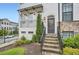 Charming townhome entrance with brick stairs, white brick facade, and inviting wrought iron details at 1780 Morningtide Ne Ln, Atlanta, GA 30324