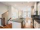 Well-lit kitchen boasts granite countertops, island with a sink, stainless appliances, and seamless access to living area at 1780 Morningtide Ne Ln, Atlanta, GA 30324