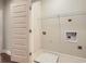 Neutral laundry room with hookups, a wire shelf, and a utility sink at 1780 Morningtide Ne Ln, Atlanta, GA 30324