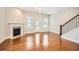 Inviting living room featuring hardwood floors, fireplace, and abundant natural light at 1780 Morningtide Ne Ln, Atlanta, GA 30324