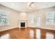 Bright living room featuring hardwood floors, a cozy fireplace, and plenty of natural light at 1780 Morningtide Ne Ln, Atlanta, GA 30324