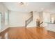 Spacious open-concept living space with hardwood floors, a staircase, and modern finishes at 1780 Morningtide Ne Ln, Atlanta, GA 30324
