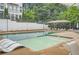 Community swimming pool with lounge chairs and shade structures at 1780 Morningtide Ne Ln, Atlanta, GA 30324