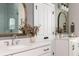 Close-up view of a bathroom with double sinks and framed mirrors at 472 Burton Dr, Alpharetta, GA 30009