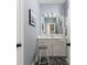 Cozy bathroom with white vanity, framed mirror and decorative black and white patterned rug at 472 Burton Dr, Alpharetta, GA 30009