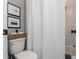 Compact bathroom featuring a shower/tub combination with white subway tile, and woven basket toilet paper holder at 472 Burton Dr, Alpharetta, GA 30009