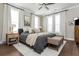 Bright bedroom with hardwood floors, rug, and bench seating at the foot of the bed at 472 Burton Dr, Alpharetta, GA 30009