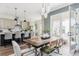 Beautiful dining area featuring French doors, a modern chandelier and views of the gourmet kitchen at 472 Burton Dr, Alpharetta, GA 30009