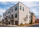 Modern townhome exterior with brick facade, dark-framed windows, and manicured landscaping for sophisticated curb appeal at 472 Burton Dr, Alpharetta, GA 30009