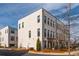 Corner unit townhome featuring a painted brick facade and professional landscaping at 472 Burton Dr, Alpharetta, GA 30009