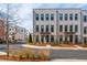 Attractive exterior view of a three-story townhome with black framed windows and professional landscaping at 472 Burton Dr, Alpharetta, GA 30009
