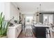 Bright kitchen boasts ample counter space, stainless steel appliances, and a dark island at 472 Burton Dr, Alpharetta, GA 30009