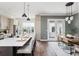 Open concept kitchen and dining area featuring hardwood floors, stainless appliances, and a stylish dining set at 472 Burton Dr, Alpharetta, GA 30009