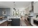 Spacious kitchen with a dark island connects to the dining and living spaces at 472 Burton Dr, Alpharetta, GA 30009