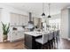 Open concept kitchen featuring stainless steel appliances, a large island, and stylish lighting at 472 Burton Dr, Alpharetta, GA 30009