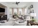 Inviting living room with modern ceiling fan, stylish decor, hardwood floors and plenty of natural light at 472 Burton Dr, Alpharetta, GA 30009