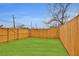 Fenced backyard with well-maintained green lawn, offering privacy and space at 701 Smith St, Atlanta, GA 30310