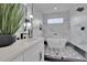 Modern bathroom featuring a marble-walled shower, soaking tub, and geometric tile flooring at 701 Smith St, Atlanta, GA 30310
