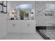 Stunning bathroom featuring a double vanity, modern mirrors, soaking tub, and chic black and white tile accents at 701 Smith St, Atlanta, GA 30310