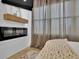 Bedroom with a fireplace, tv, light-filtering curtains, and hardwood flooring at 701 Smith St, Atlanta, GA 30310