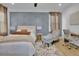 Stylish bedroom with a cozy rug, textured gray accent wall, and modern furniture at 701 Smith St, Atlanta, GA 30310